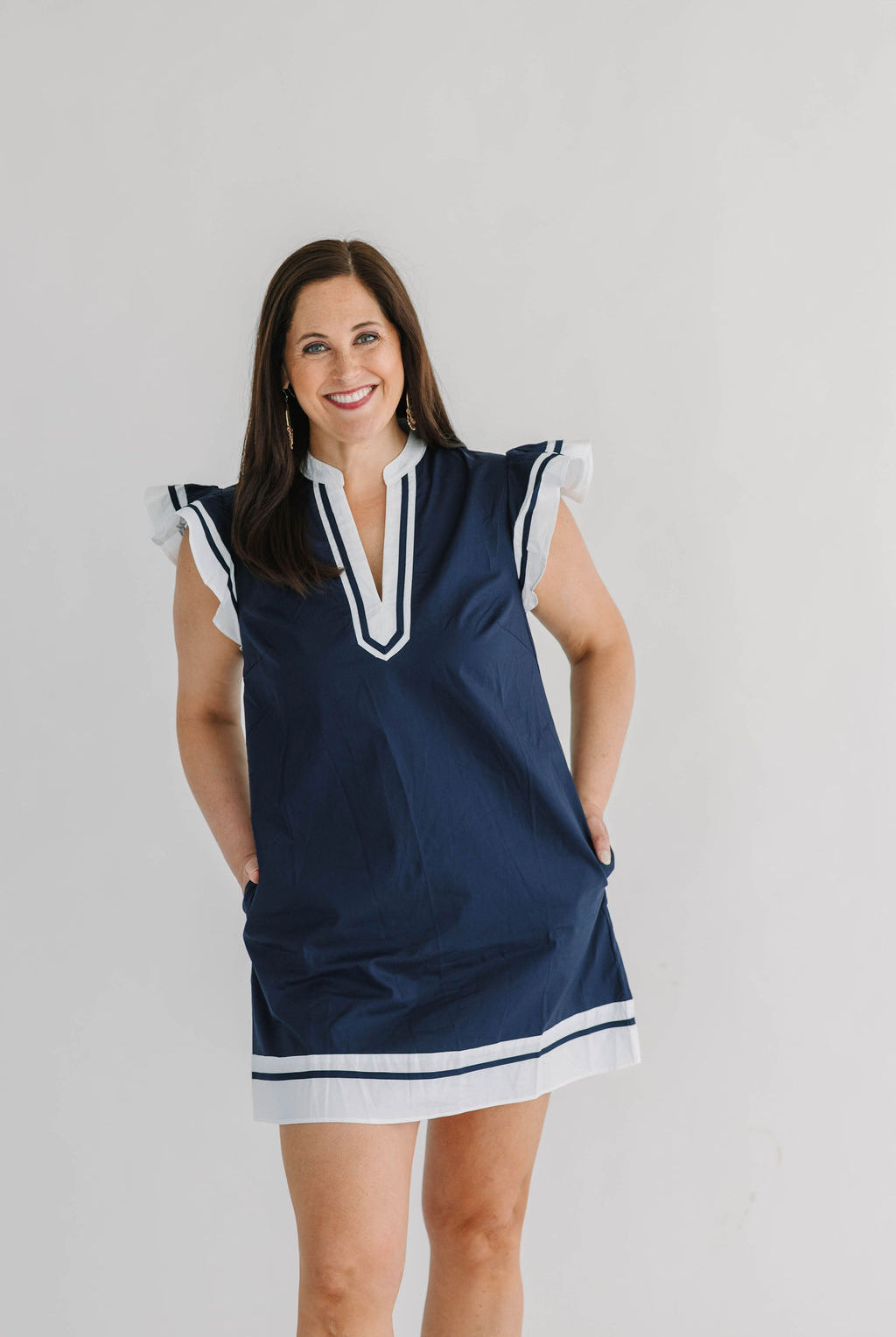 navy shift pocket dress with white trim, v-neck and flutter sleeves