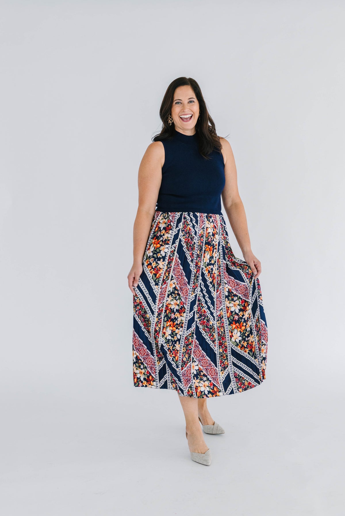 dress with sleeveless navy mock neck knit top and pleated floral skirt