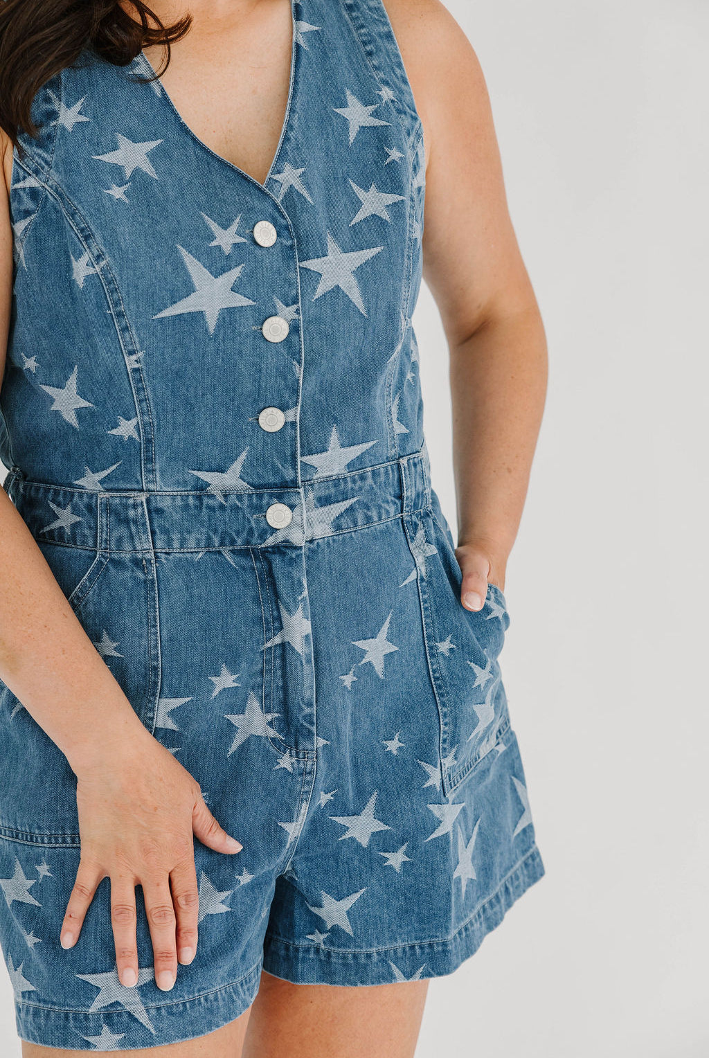 Denim romper with star pattern functioning button and zipper closure