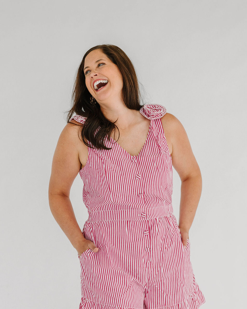 red and white striped romper with floral detail on strap
