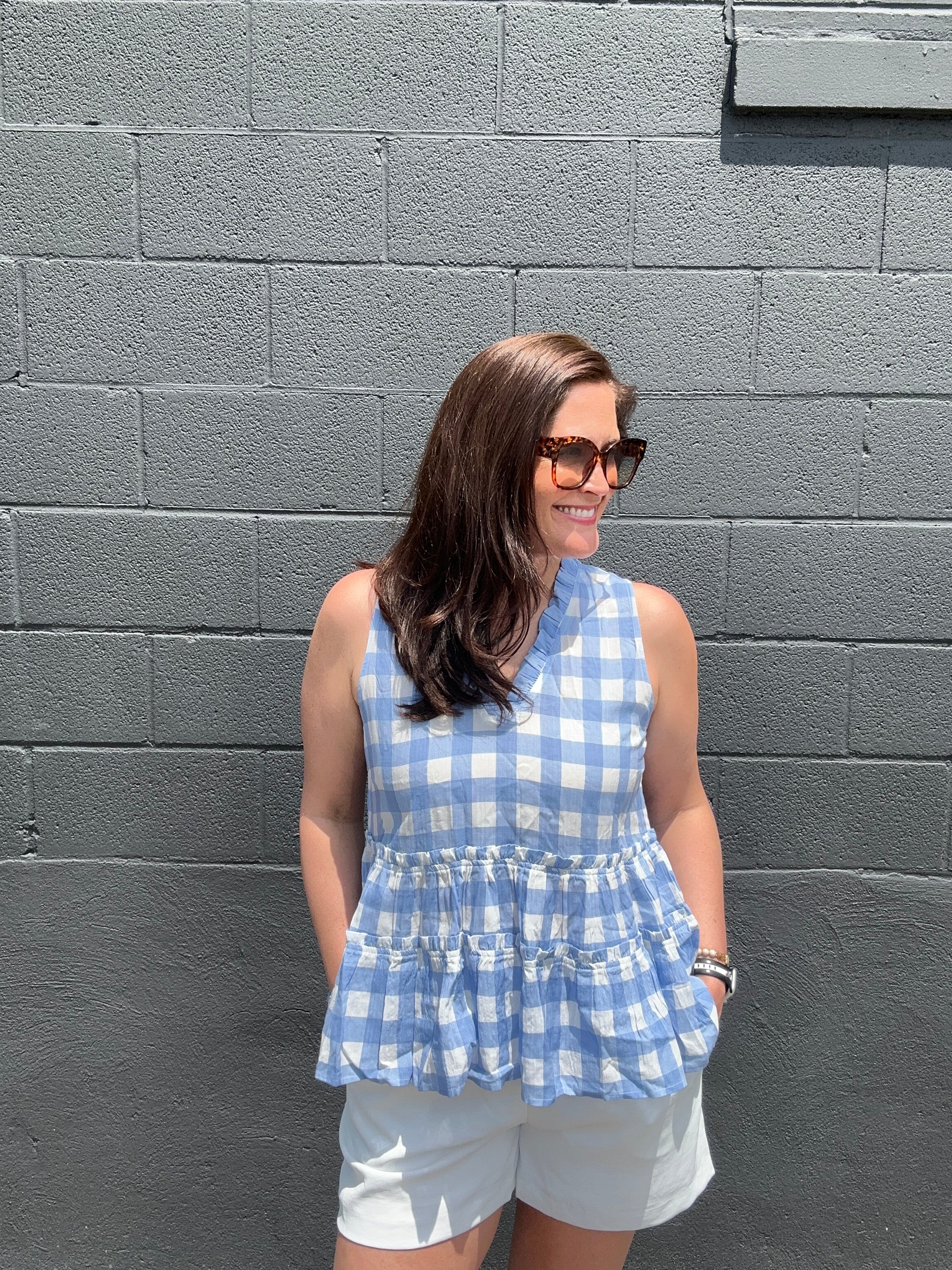 blue and white checkered sleeveless v-neck ruffled peplum top