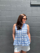 blue and white checkered sleeveless v-neck ruffled peplum top
