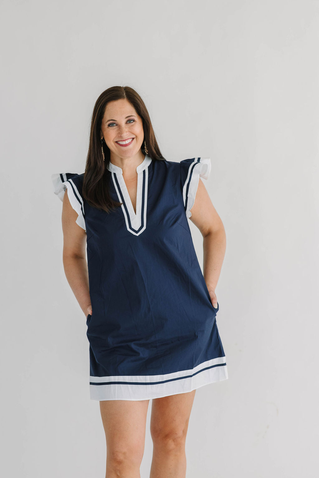 navy shift pocket dress with white trim, v-neck and flutter sleeves