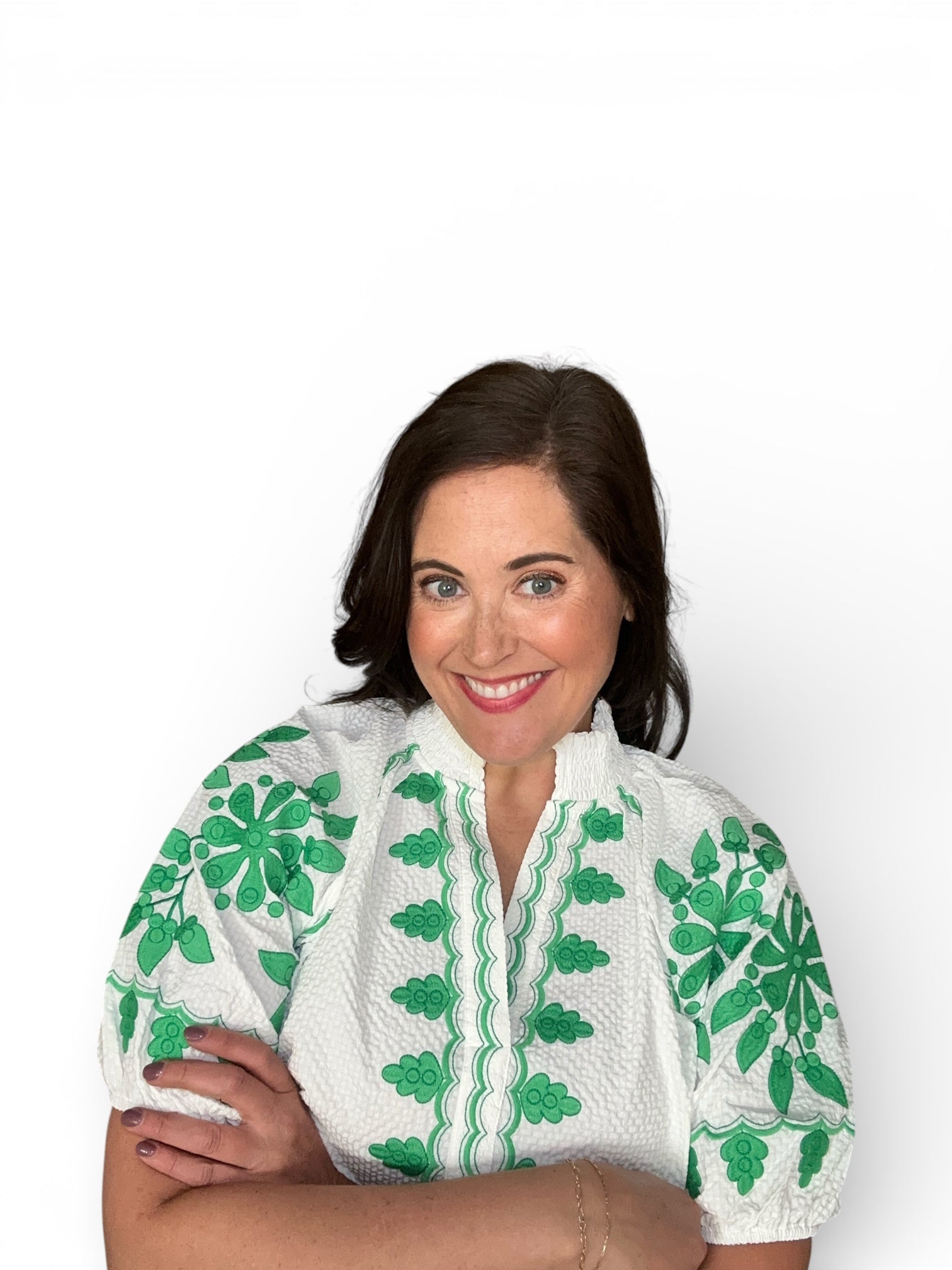 white textured v-neck puff sleeve top with green embroidered sleeve and front 