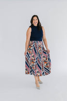 dress with sleeveless navy mock neck knit  top and pleated floral skirt 