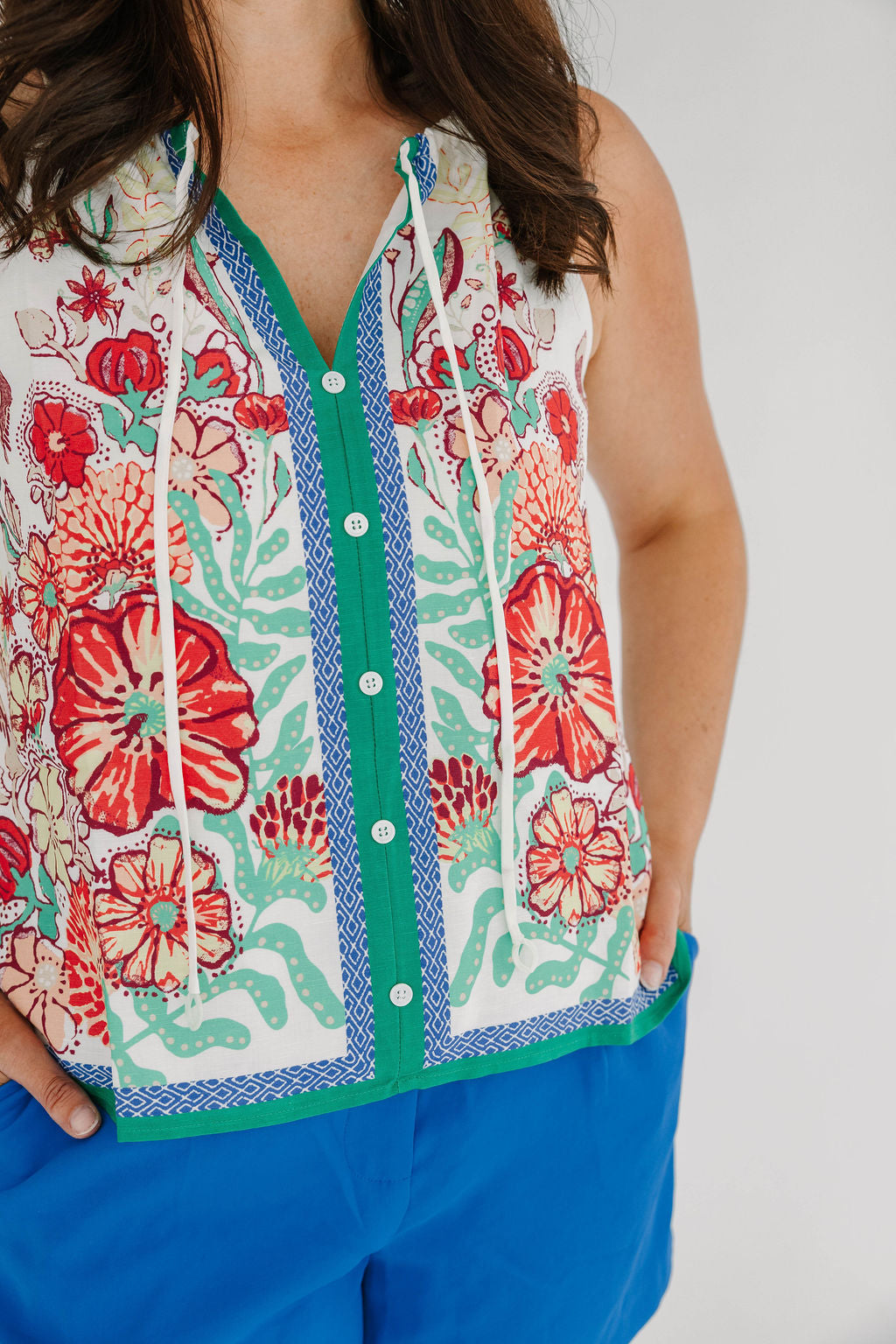 sleeveless halter floral top with button nonfunctional buttons and tie detail