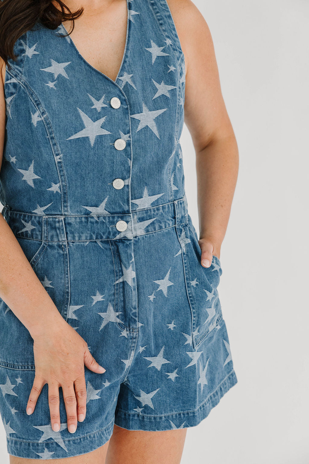Denim romper with star pattern functioning button and zipper closure