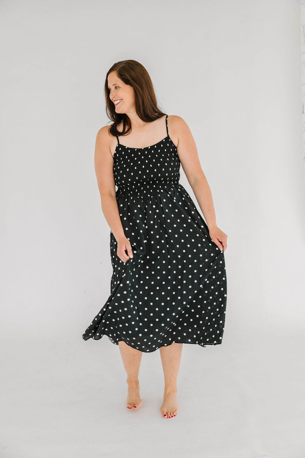 black with white polka dot midi dress with smocked top and spaghetti straps