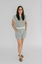 cream & black striped knit romper with open back, elastic tie waist and neck closure